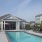 a swimming pool with a house in the background