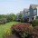 a house with a large lawn and a large flower bed